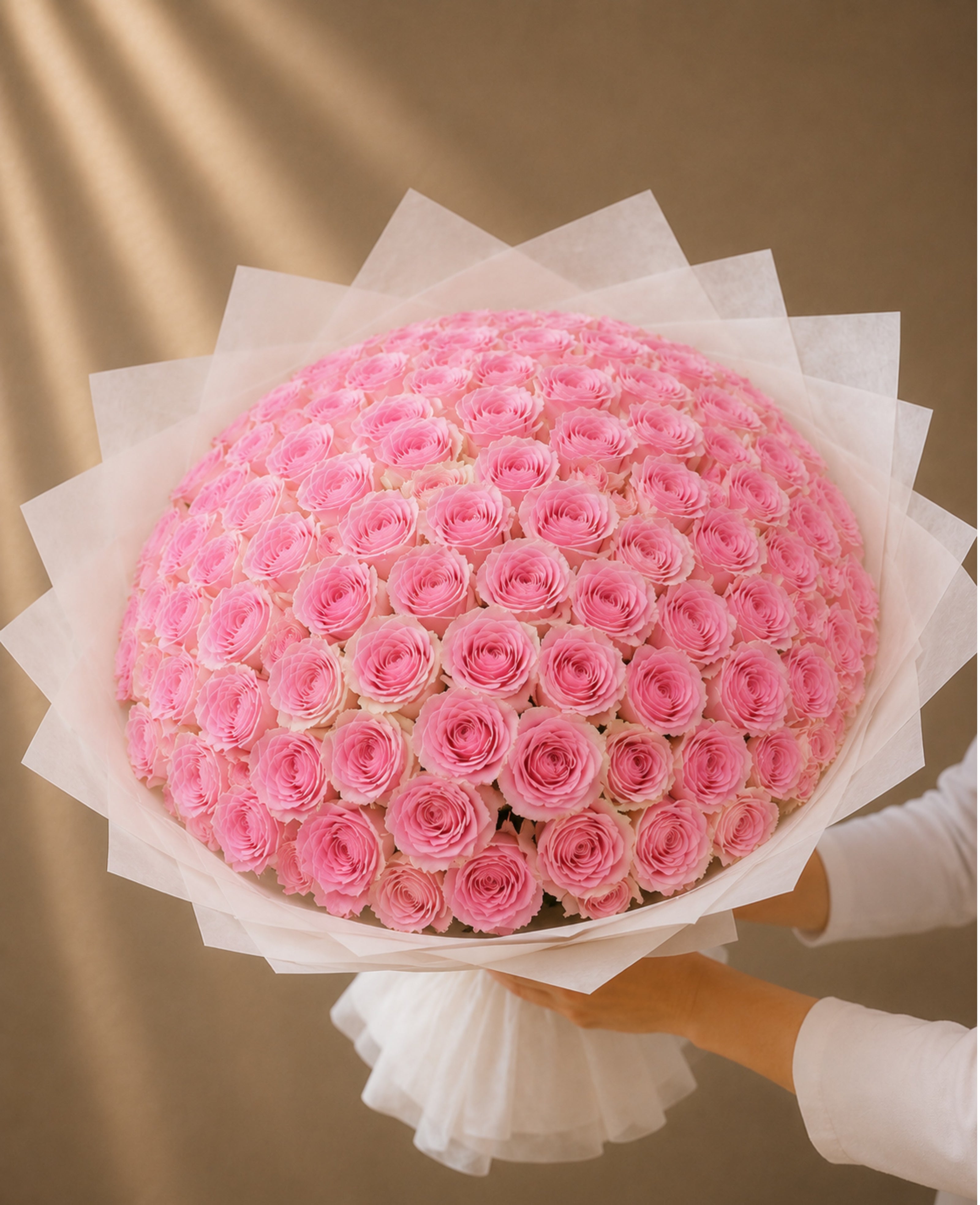 Luxury bouquet of 101 premium Esperance pink roses wrapped in elegant white designer wrapping by Ishbelia Gardens Dubai.